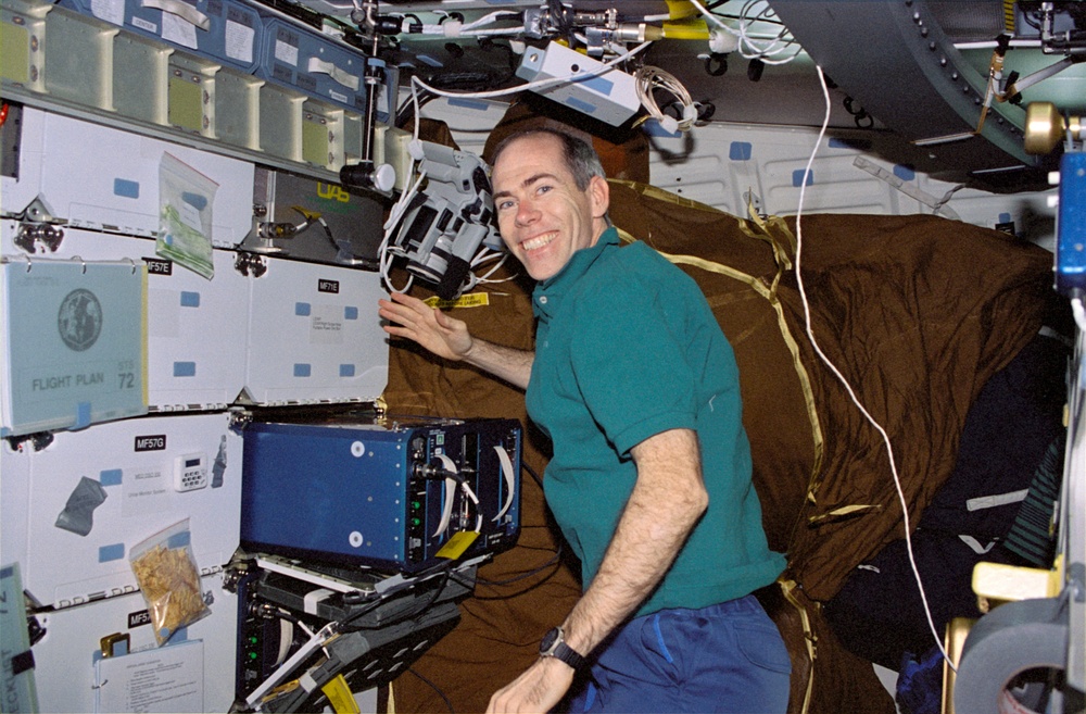 PARE/NIH-R, Mission Specialist Daniel Barry checks on middeck experiment