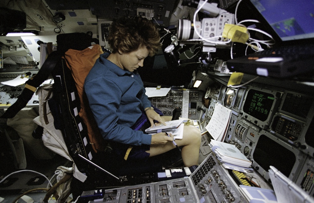 Commander Collins seated in the flight deck commander's station