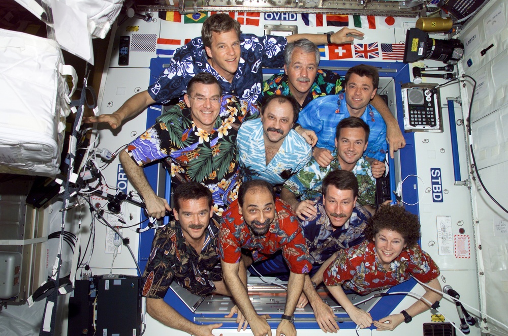 The STS-100 and Expedition Two crews pose for a group photo in the U.S. Laboratory