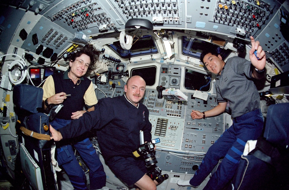Tani, Godwin and Kelly pose on the flight deck during STS-108