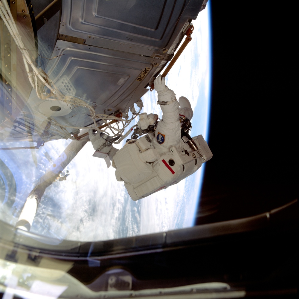 MS Hadfield translates across the U.S. Laboratory during the first EVA for STS-100