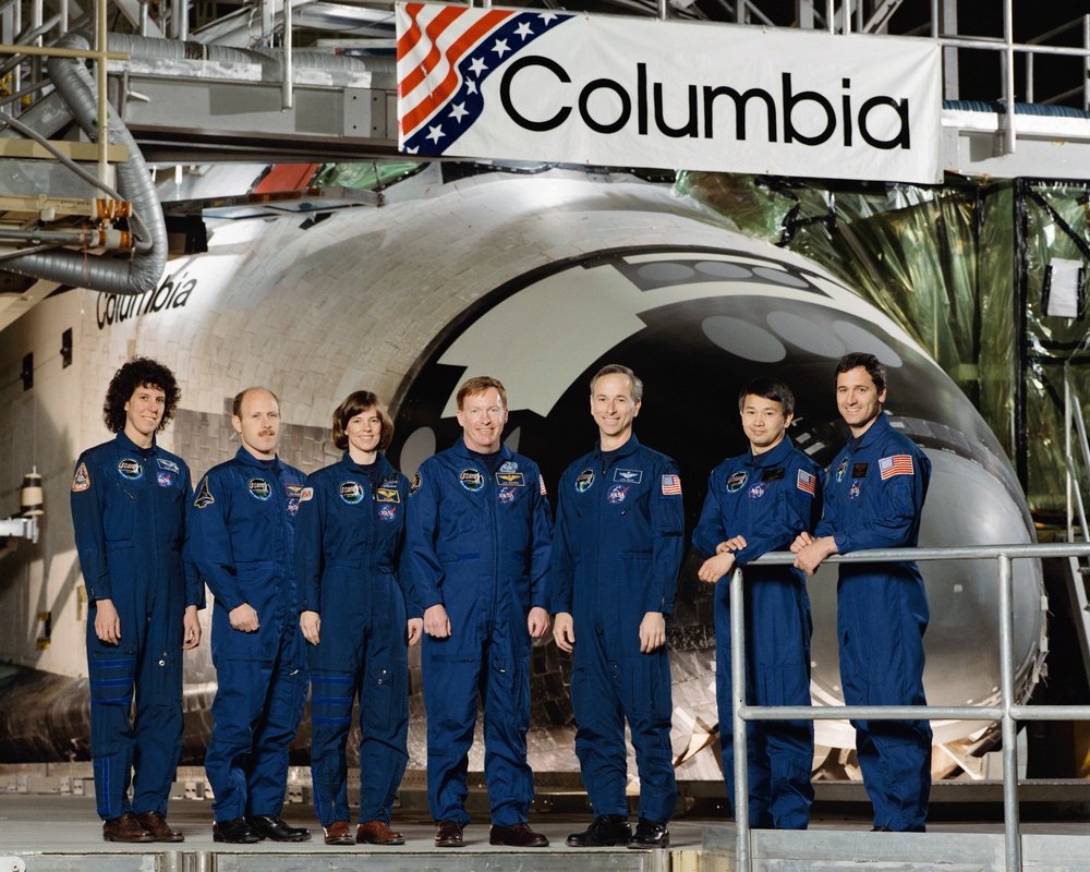 STS-50 USML-1 crew poses for their official portrait in front of OV-102