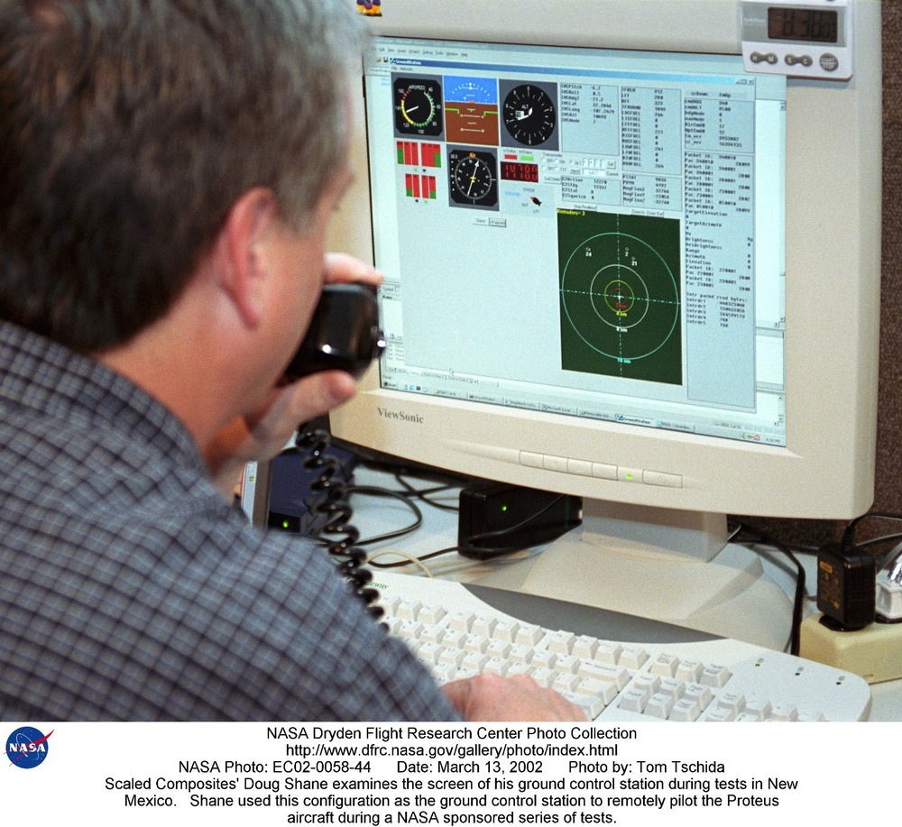 Scaled Composites' Doug Shane examines the screen of his ground control station during tests in New
