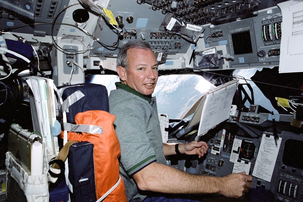 Crewmembers pose for photos in the flight deck