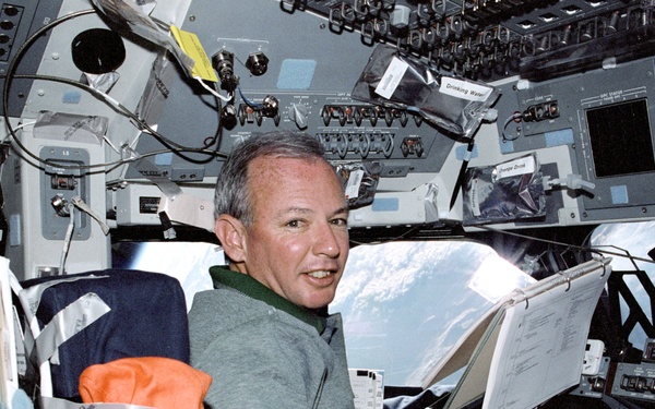 Crewmembers pose for photos in the flight deck