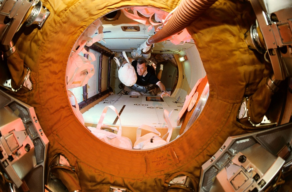 Astronaut Wilcutt with water transfer bag in docking module