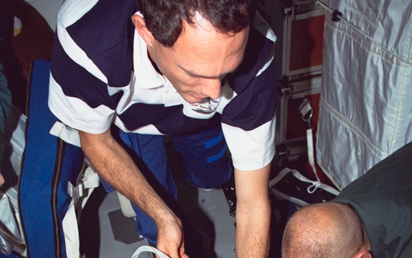 Various views of the STS-88 crew on the flight deck and middeck