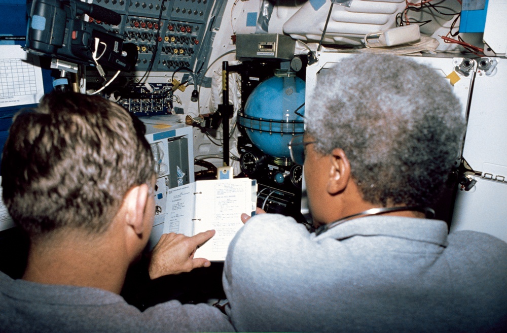 Crewmembers in middeck with the Fluid Acquisition and Resupply Equipment exp.
