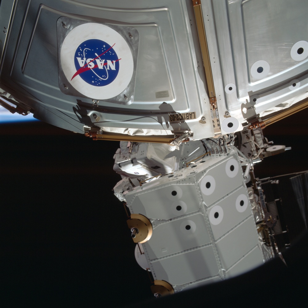 MS Parazynski works on the U.S. Laboratory during the first EVA for STS-100