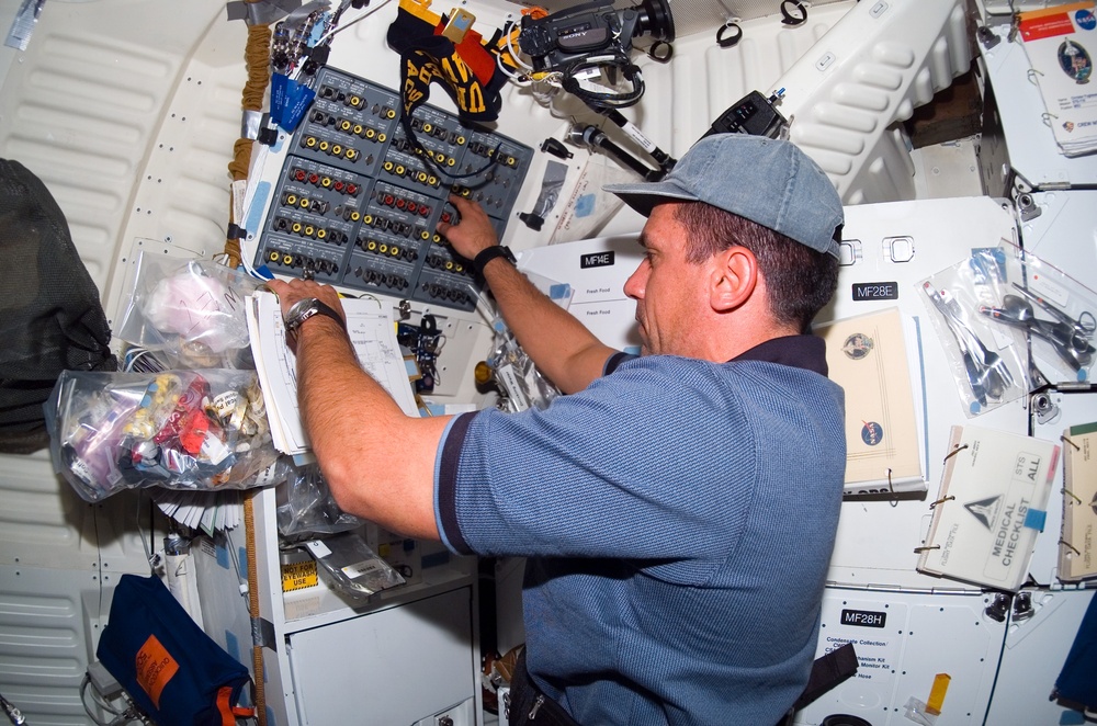 STS-116 MS Patrick works at control panel in the MDDK on Space Shuttle Discovery