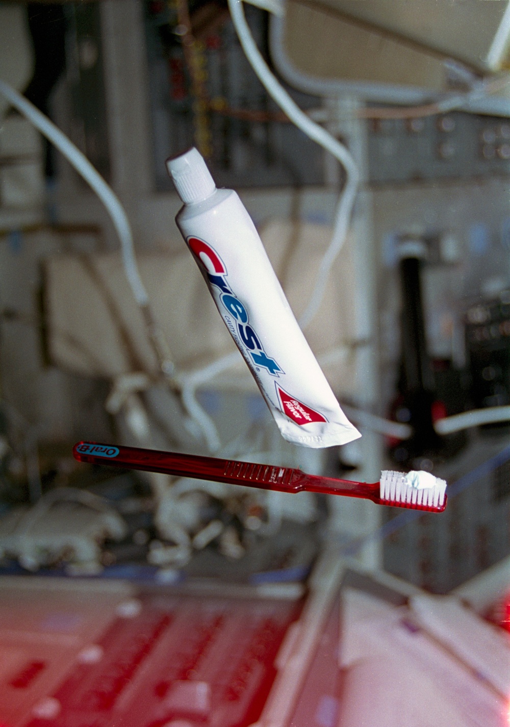 Toothbrush and tube of toothpaste floating in the flight deck