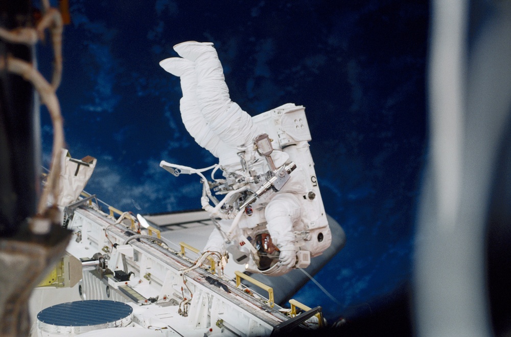 Helms translating along the payload bay sill during an EVA