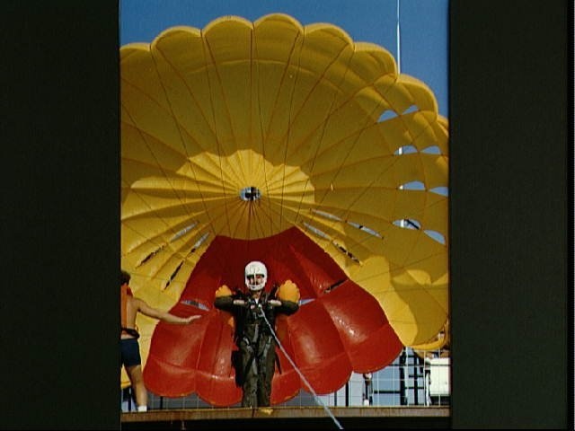 Astronaut Jon McBride in parachute during Water Survival Training activities