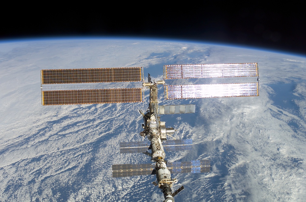 The aft - zenith side of the ISS taken during the STS-108 undocking and flyaround