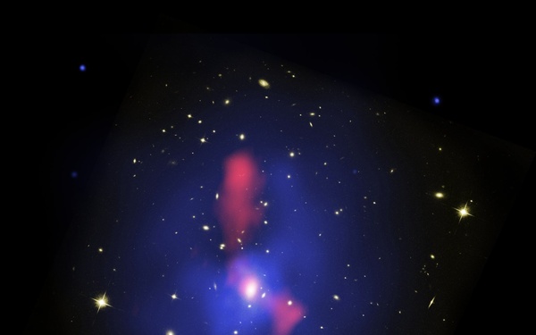 Host Galaxy Cluster to Largest Known Radio Eruption