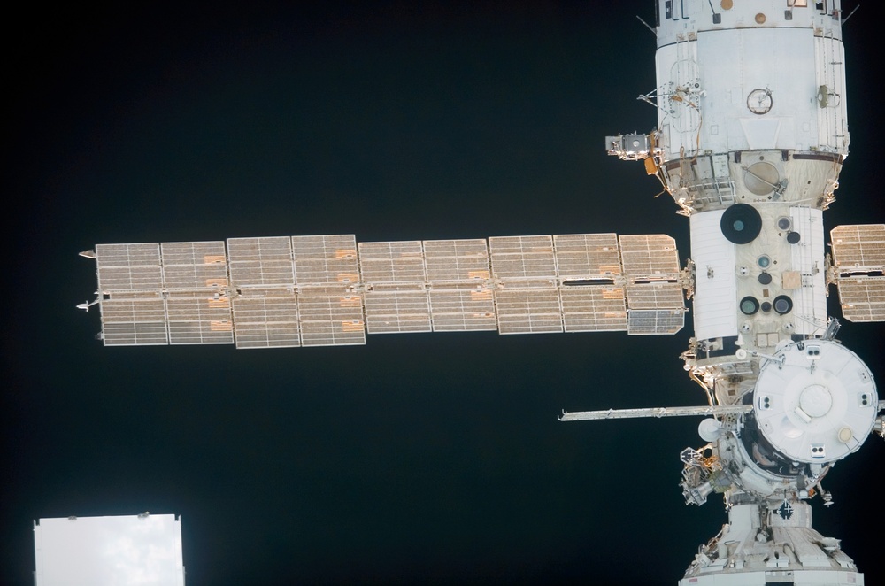 Soyuz vehicle and SM as the orbiter Discovery moves in for docking during STS-121