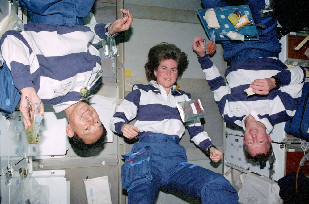 STS-99 Mohri, Voss and Gorie pose during a meal on OV-105's middeck