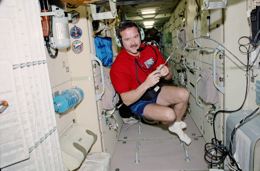 MS Hadfield uses the HAM radio in Zarya during STS-100