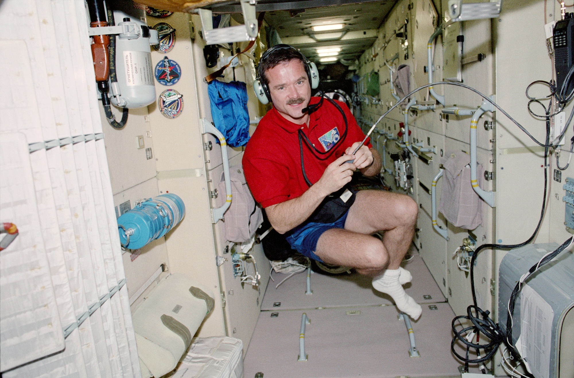 Images - MS Hadfield uses the HAM radio in Zarya during STS-100 pic