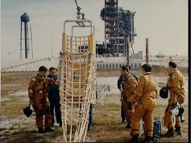 STS-1 crew and backups are briefed on KSC slide wire system by G.W.S. Abbey