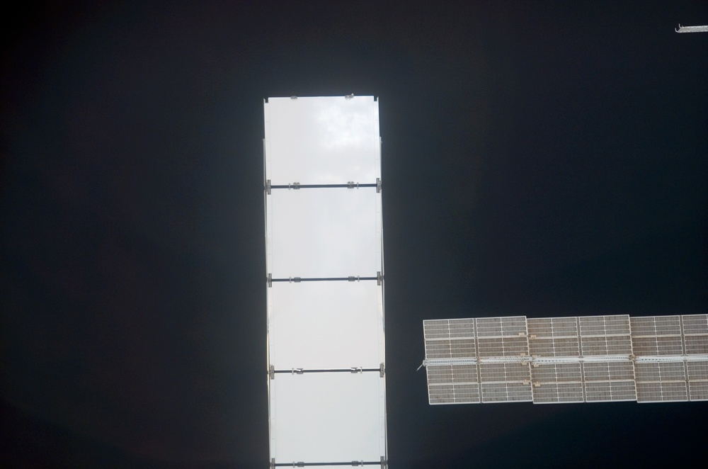 Starboard solar arrays on the ISS as the orbiter Discovery moves in for docking during STS-121