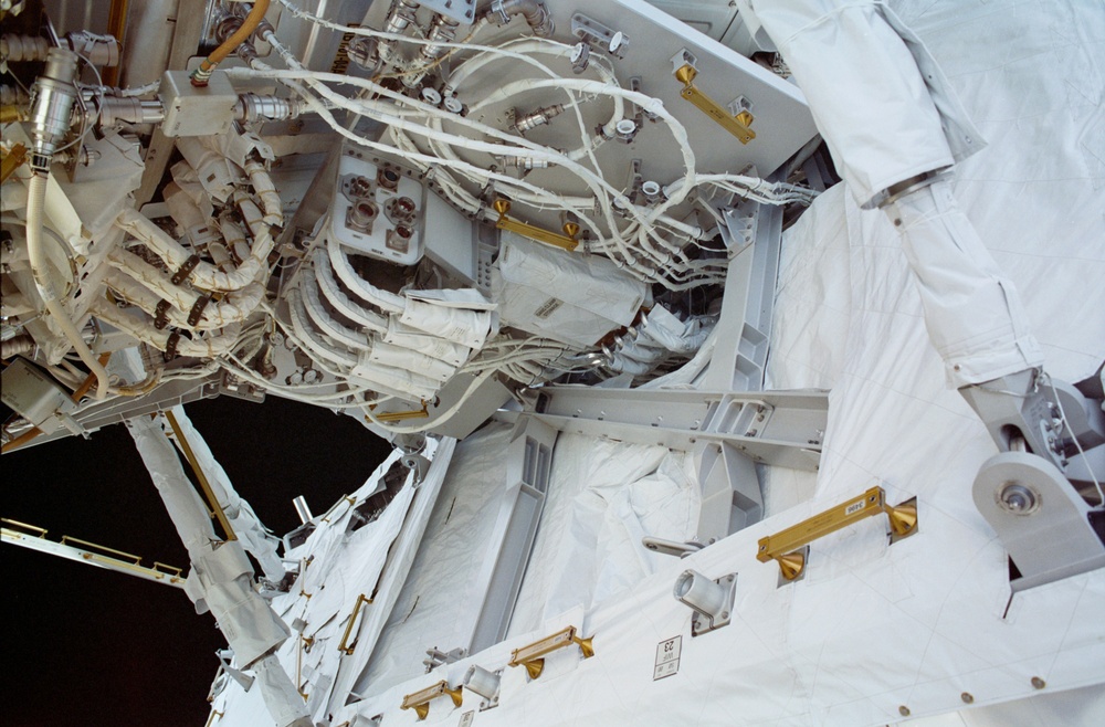 View of the aft avionics tray between the Z1 and S0 Trusses taken during the fourth EVA of STS-110