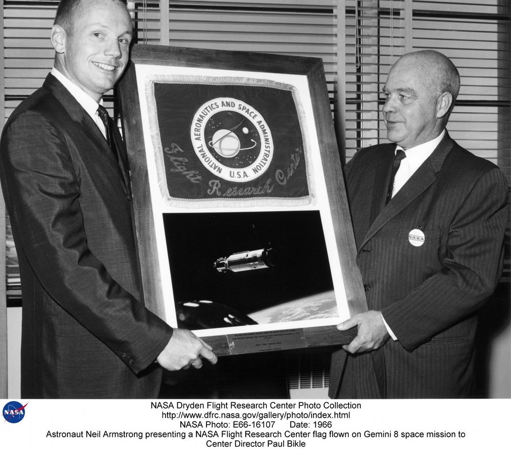 Astronaut Neil Armstrong presenting a NASA Flight Research Center flag flown on Gemini 8 space missi