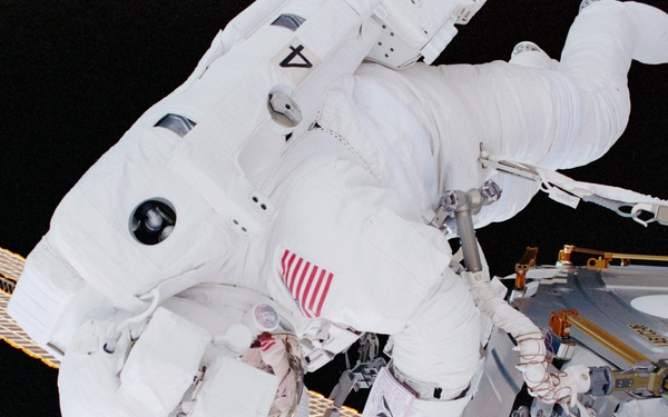 MS Parazynski drives in a bolt for the UHF antenna on Destiny during the first EVA of STS-100