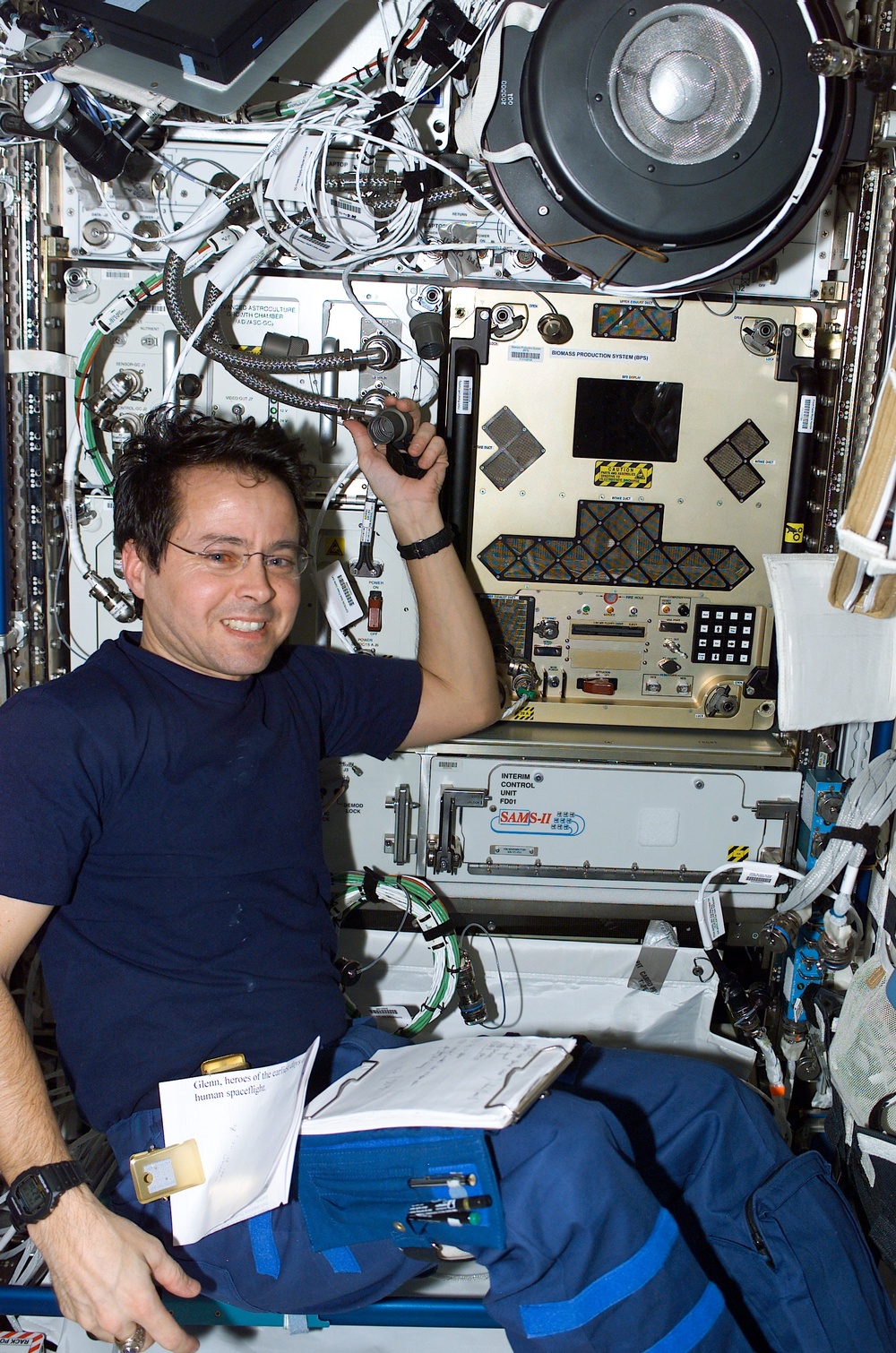 Bursch poses by the BPS experiment in Destiny during STS-110's visit to the ISS