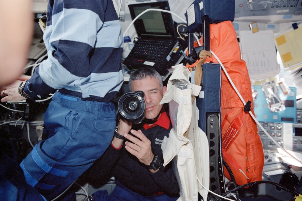 Walheim and Morin work on the flight deck during the initial flyaround of STS-110
