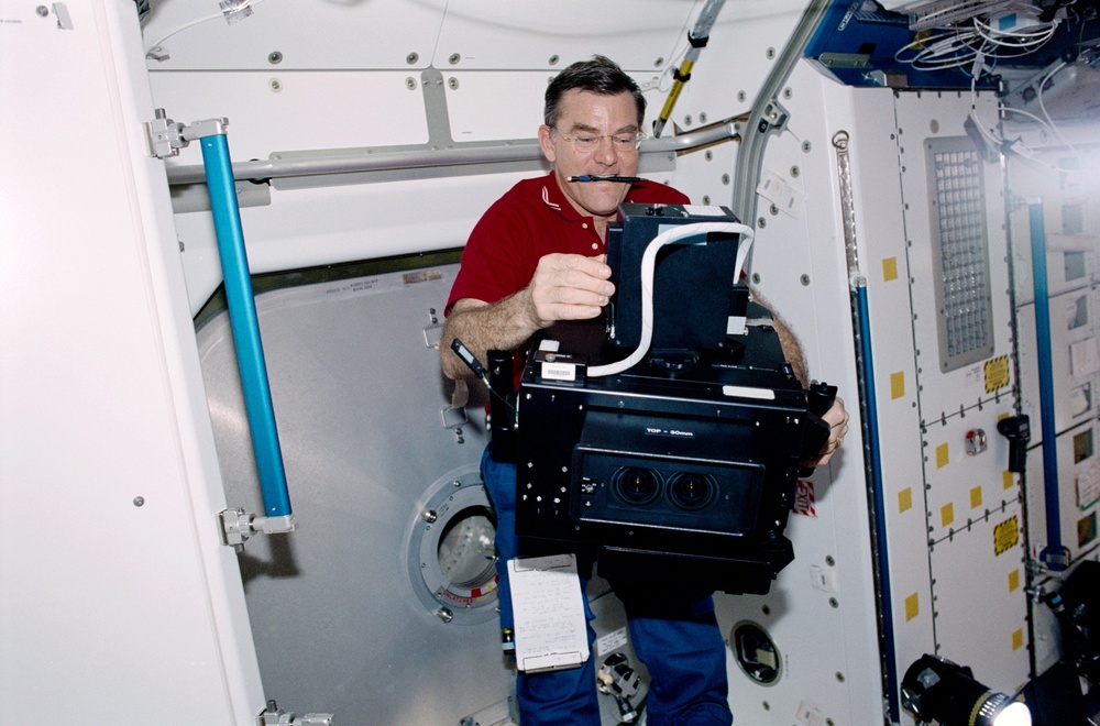 Expedition Two's Voss works with the IMAX camera in Node 1 during the STS-100 visit