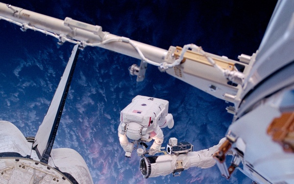 Barry on the RMS above the payload bay during EVA2