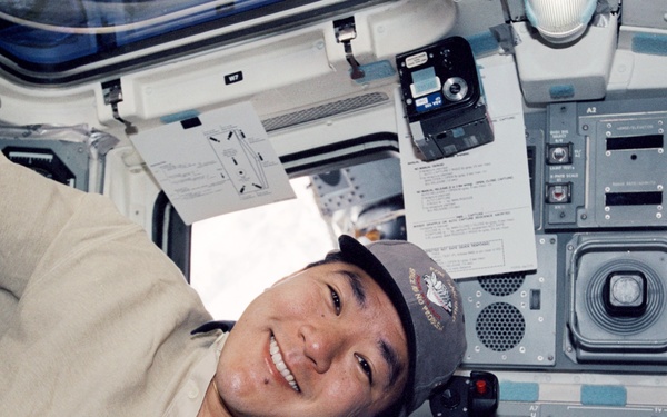 MS Tani poses with FDF's on the flight deck during STS-108