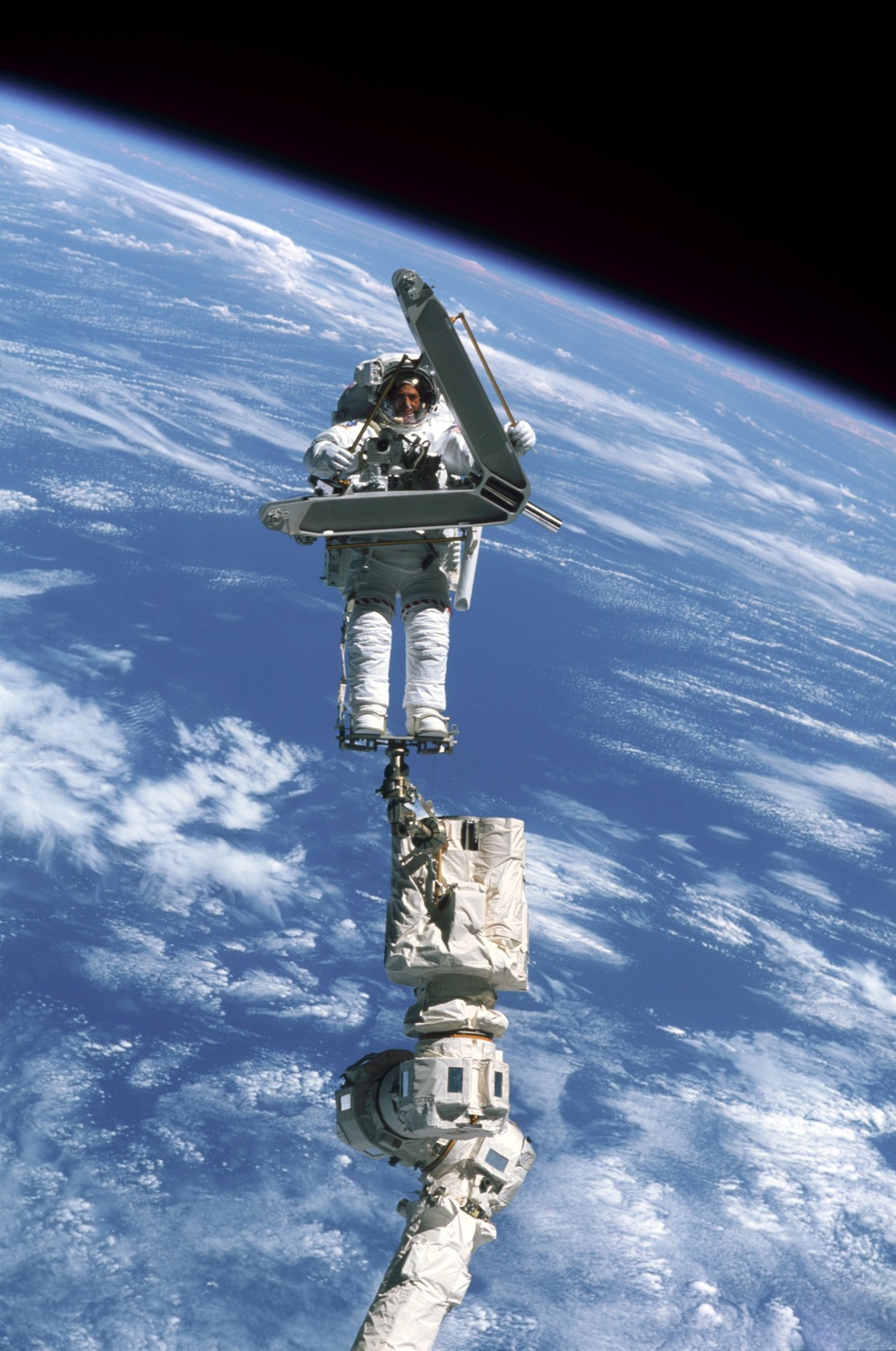 Morin handles a keel pin and is moved by the SSRMS during the second EVA of STS-110