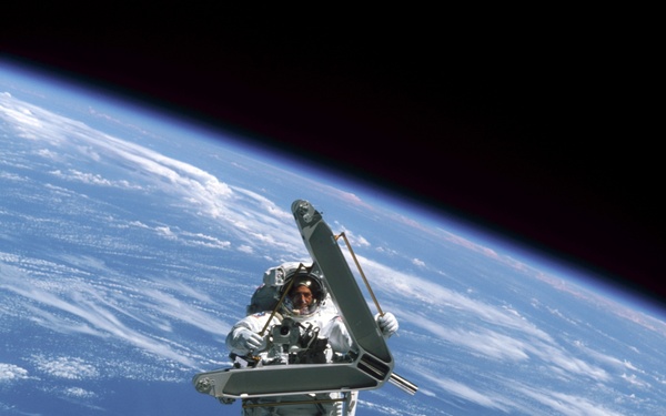 Morin handles a keel pin and is moved by the SSRMS during the second EVA of STS-110