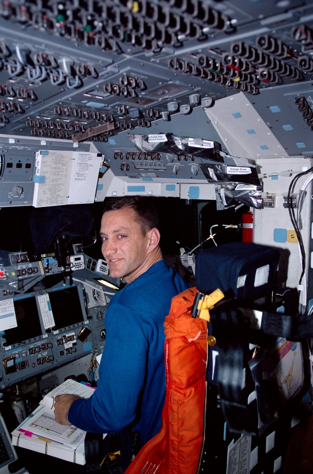 STS-104 PLT Hobaugh on the forward flight deck with checklist