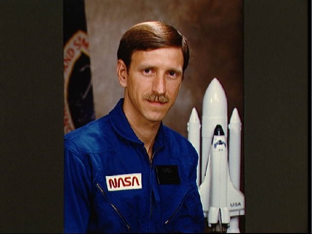 Portrait of Astronaut candidate Richard O. Covey in blue flight suit.