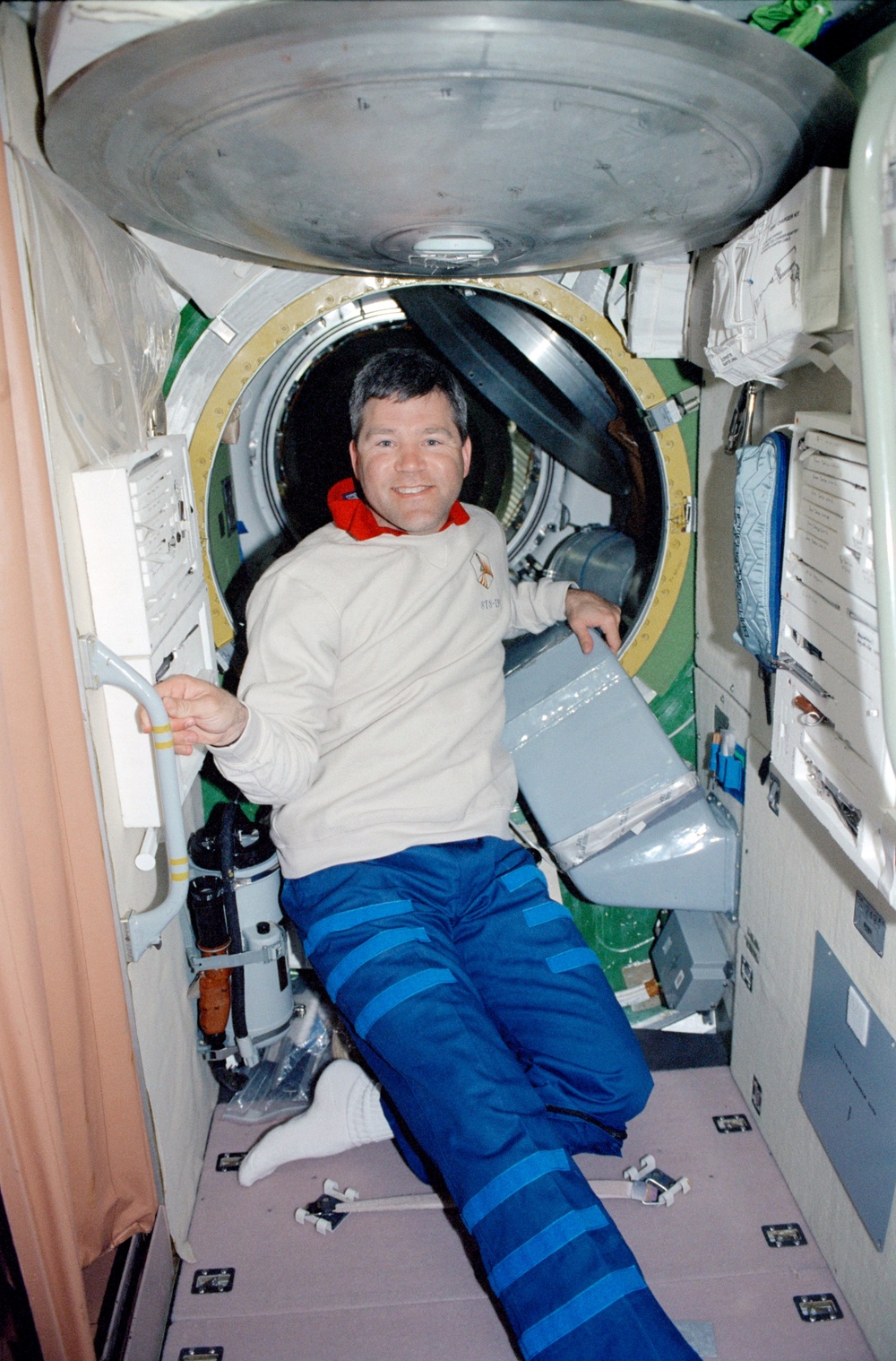 Pilot Frick poses in the Service Module during STS-110