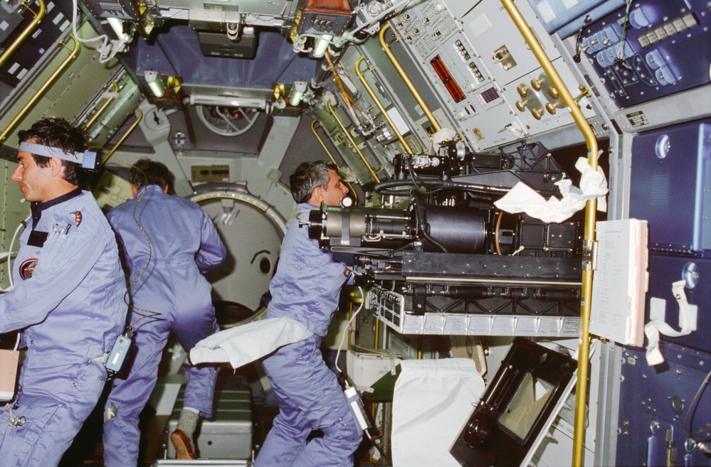 STS-9 crewmembers work in the Spacelab 1 module