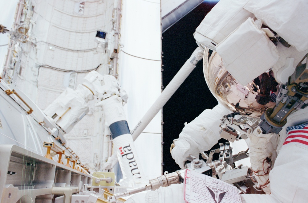 MS Parazynski secures the DCSU on Destiny with a PGT during the second EVA of STS-100