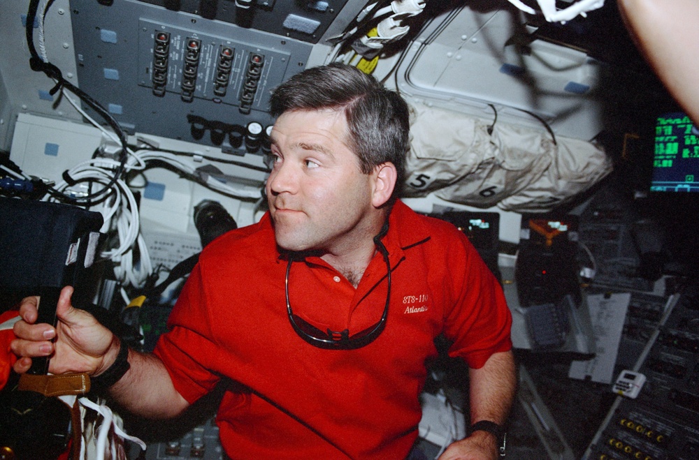Pilot Frick works on the aft flight deck during the final flyaround of STS-110