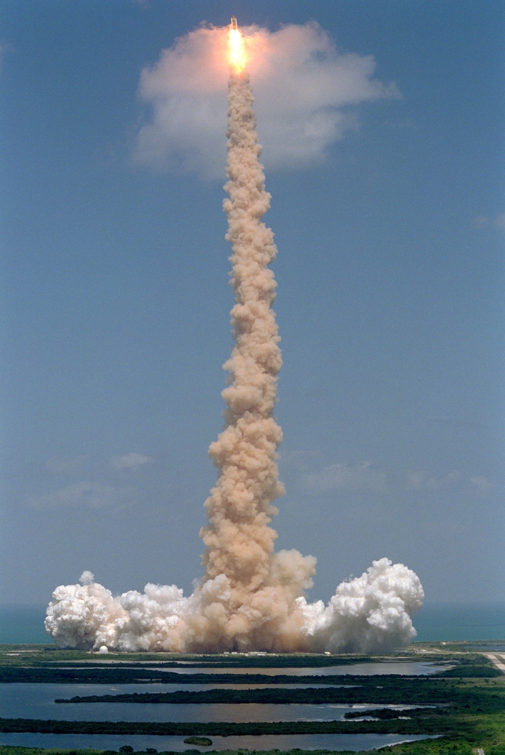 View of Endeavour climbing into the sky and breaking through a cloud during the STS-100 launch