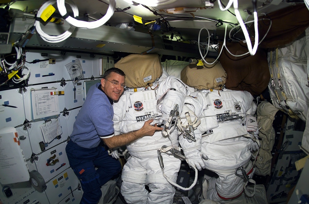 Voss poses for a photo with his EMU suit