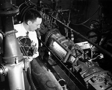 ENGINEER TAKING MOTION PICTURES OF COMBUSTION IN TRANSPARENT COMBUSTOR AND LINER