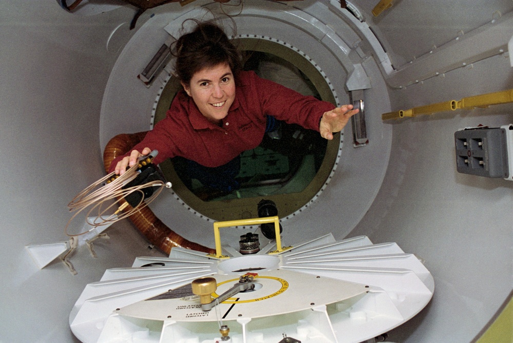 Candid views of a crewmember in the SPACEHAB access tunnel.