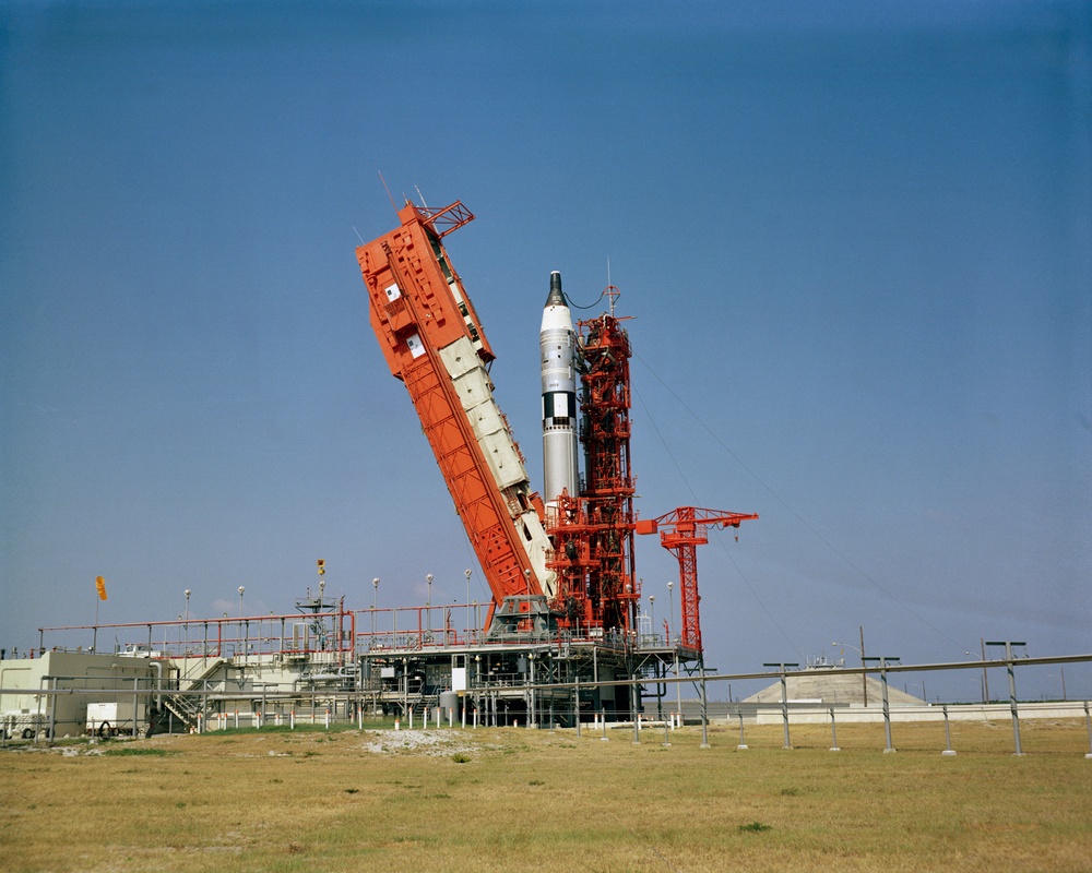 View of the Gemini-Titan 4 spacecraft on Pad 19 with erector being removed