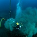 US Navy divers, alongside the Joint POW/MIA Accounting Command, search for an unaccounted-for service member who went missing during World War II