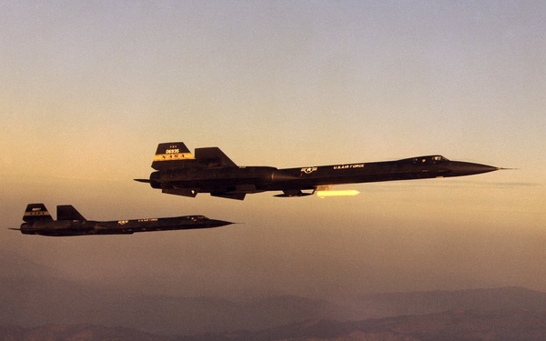 YF-12A and YF-12C in flight formation at dawn