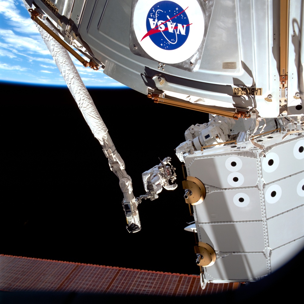 MS Hadfield works on the SSRMS during the first EVA for STS-100