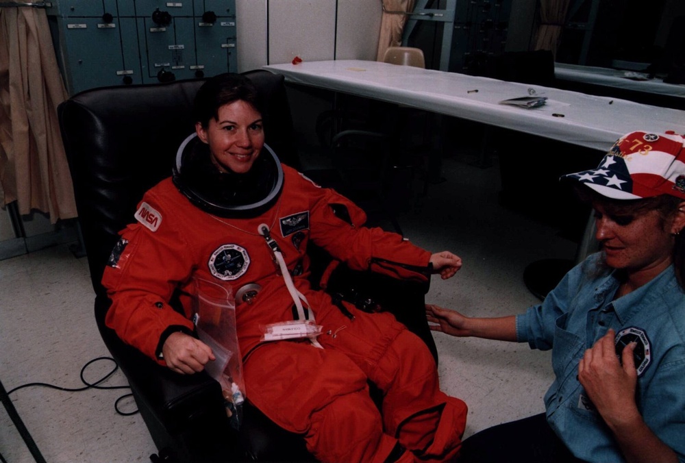 STS-73 Mission Specialist Catherine Coleman suits up